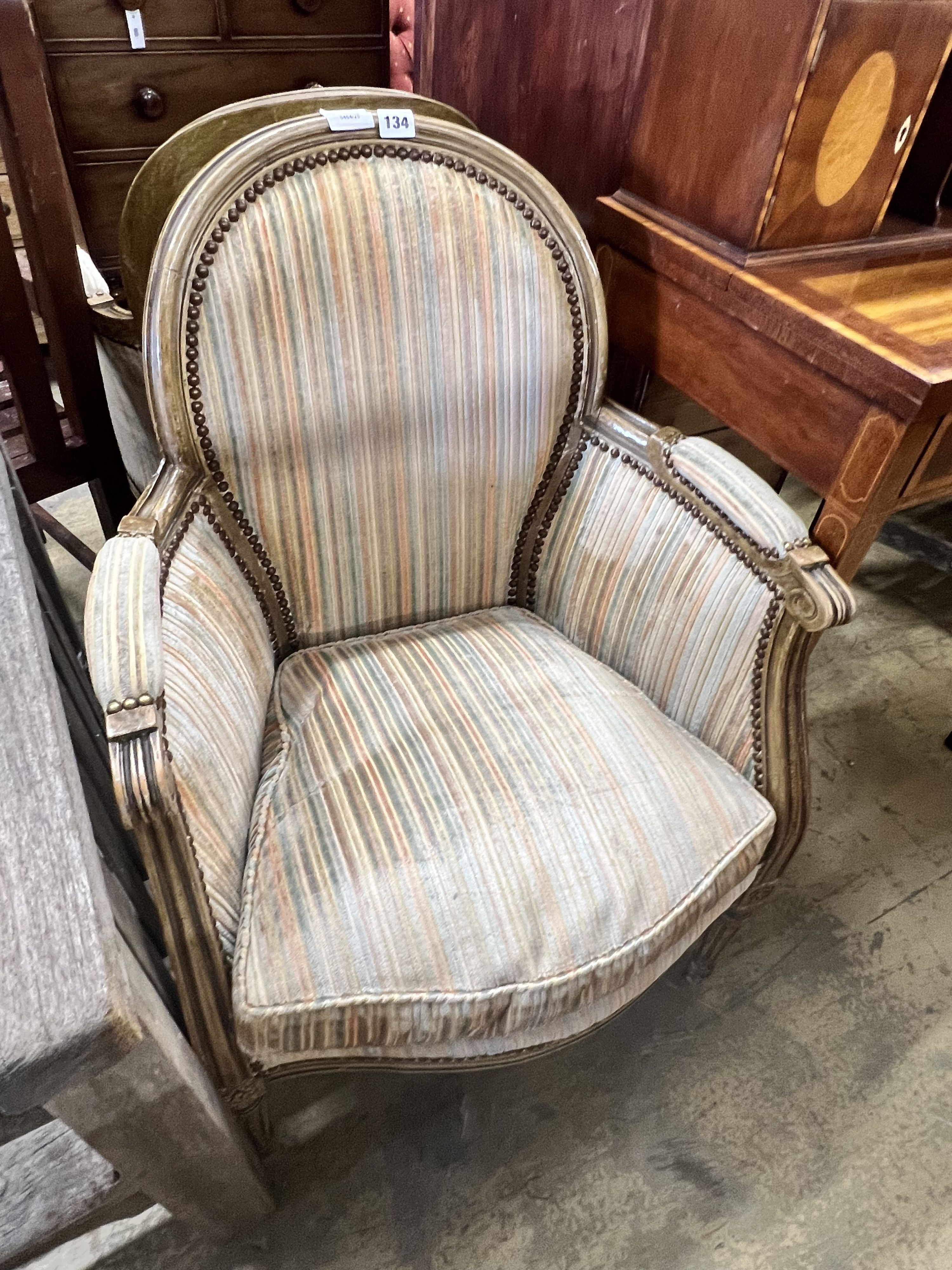 A pair of Louis XVI style painted cream show wood framed bergeres, upholstered in ribbed velvet, width 58cm depth 43cm height 86cm